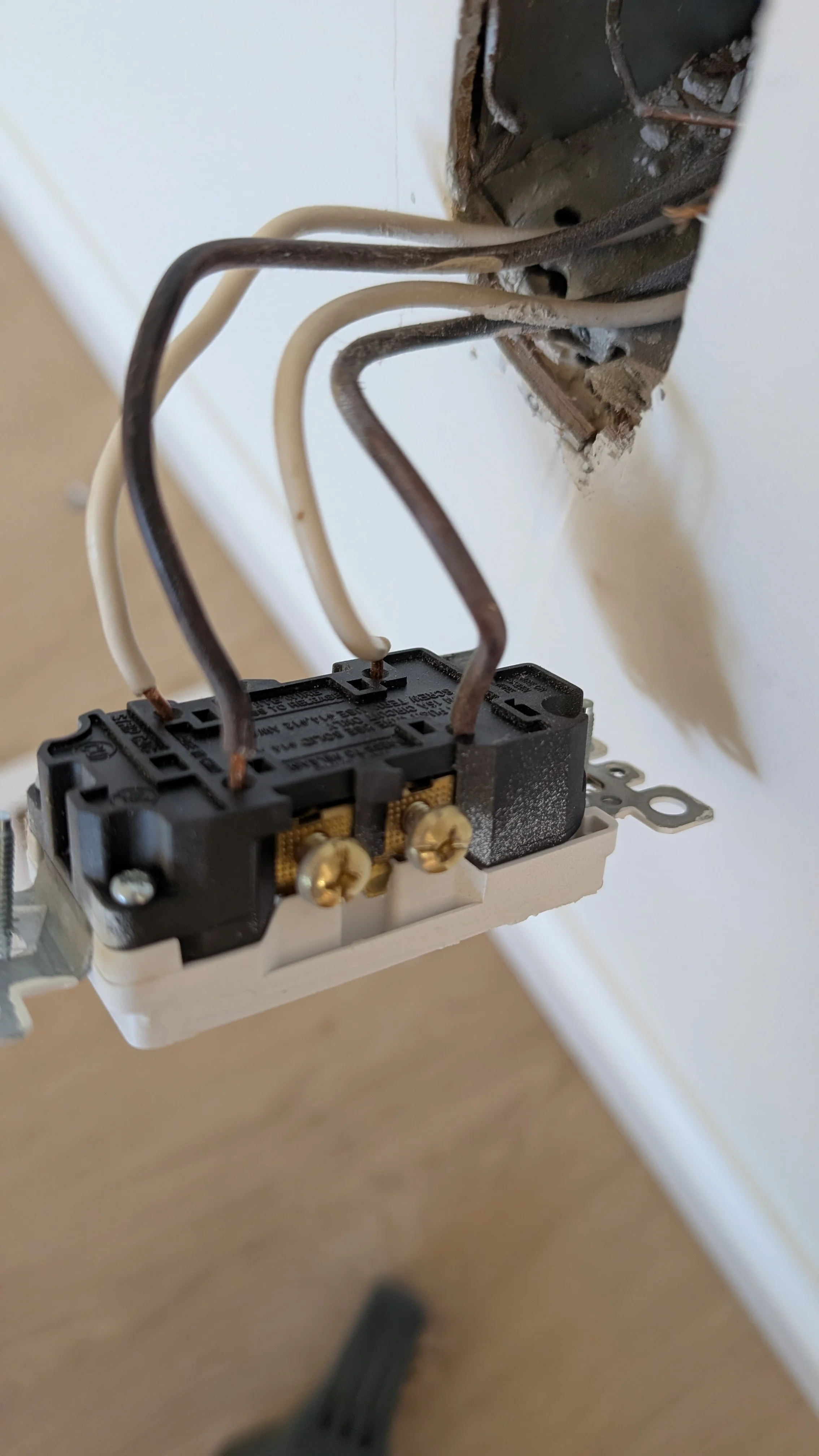 Residential electrical outlet with properly connected copper and neutral wires installed in wall box