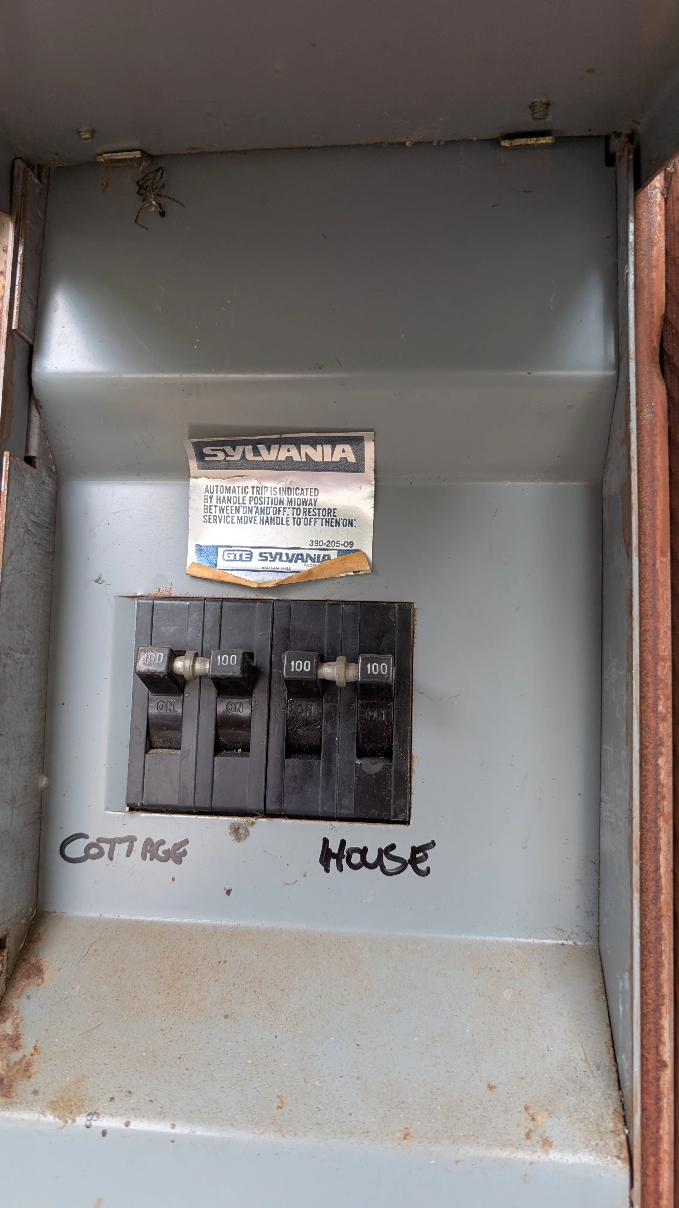 Upgraded electrical panel with four 100-amp circuit breakers and Sylvania automatic trip mechanism